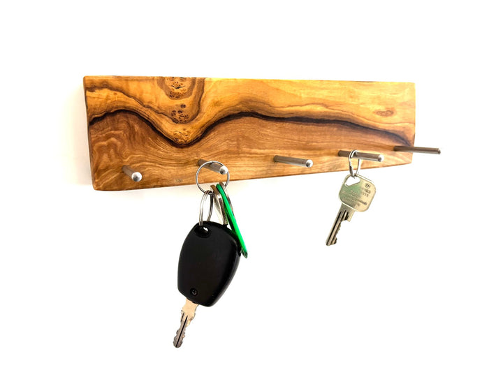 Keychain in the shape of a cross made of olive wood