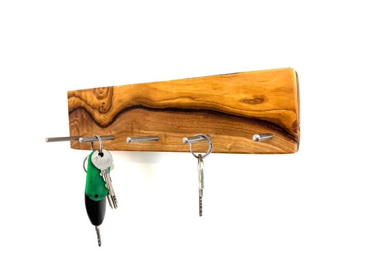 Keychain in the shape of a cross made of olive wood